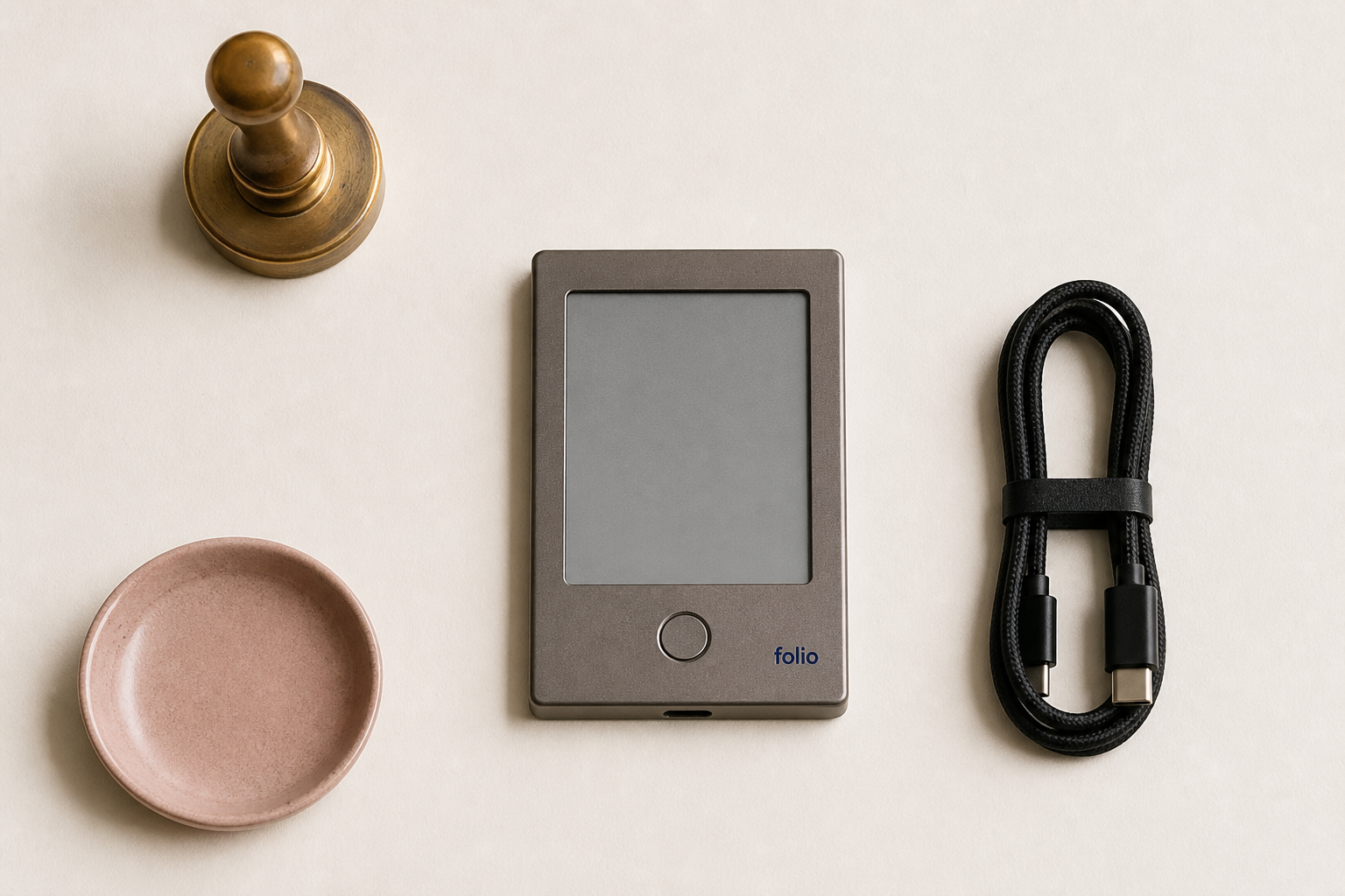 folio one with a USB-C cable, brass stamp and ceramic dish